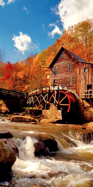Breathtaking 4K Phone Wallpaper Featuring a Serene River and Rustic Houses
