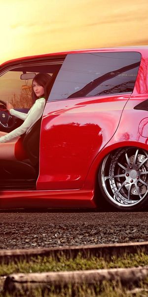 Vibrant 4K wallpaper of a Suzuki car with stylish women at sunset