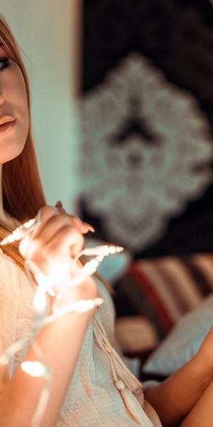 Redhead Model with Blue Eyes in Cozy Setting