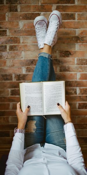 Girl Enjoying a Book in Comfortable Sneakers