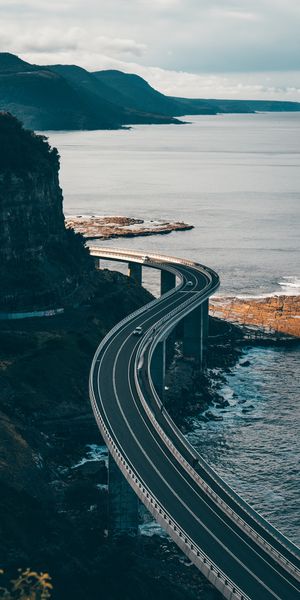 Breathtaking HD phone wallpaper of a winding coastal road by the sea