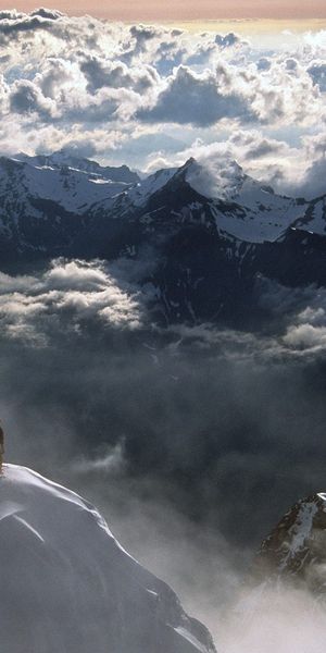 Epic mobile wallpaper of extreme climbing in the Swiss Alps with clouds