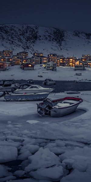 Phone wallpaper: Winter, Ice, Night, Snow, Light, Village, Boat, Man Made free download