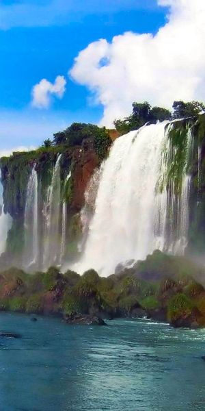 Vibrant mobile wallpaper featuring a majestic waterfall and rainbow in nature