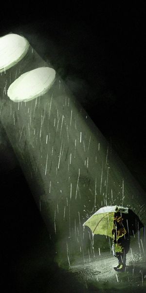 Silhouette with Umbrella Under Bright Rays in the Rain