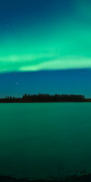 Breathtaking Aurora Borealis Over Calm Waters at Night