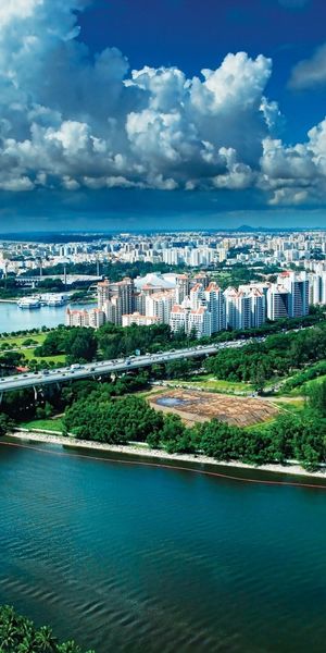 Breathtaking Singapore Cityscape Phone Wallpaper Featuring Lush Greenery and Urban Life