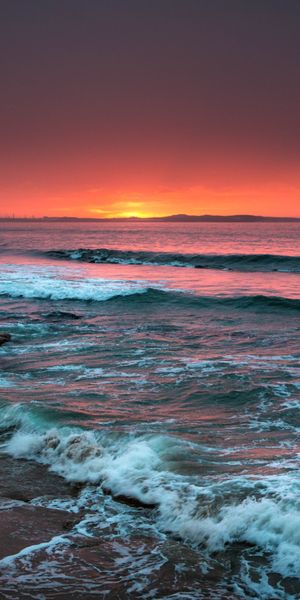 Breathtaking Sunset Over the Sea with Waves and Foam