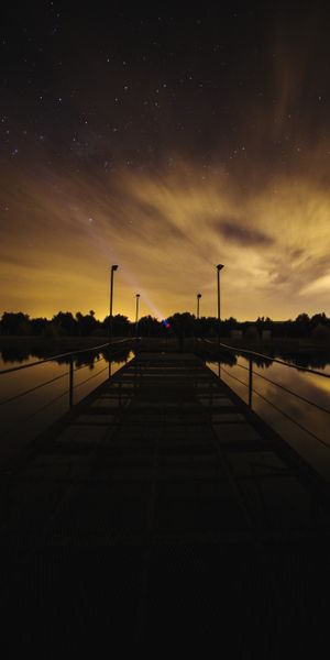 Starry Sky Over Lake with Pier: A Perfect Phone Wallpaper