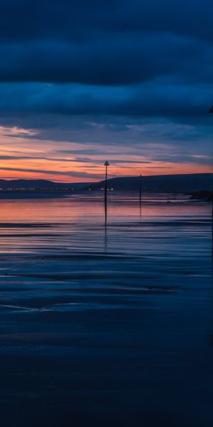 Captivating sunset wallpaper featuring clouds, sea, and twilight hues