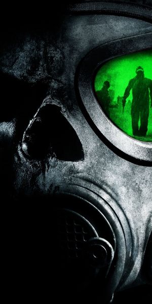 Intriguing mobile wallpaper featuring a dark gas mask with green reflections