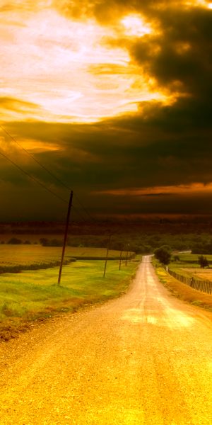 Breathtaking 4K Phone Wallpaper of a Sunset Road Through a Field