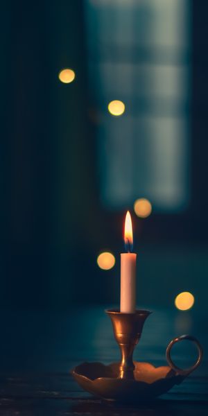 Elegant Candle with Soft Glow and Bokeh Background