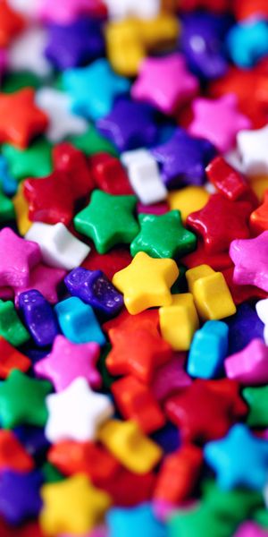 Vibrant multicolored star-shaped sweets wallpaper for cheerful decor