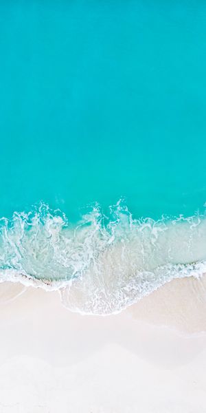 Aerial View of a Tropical Beach with Clear Blue Waves
