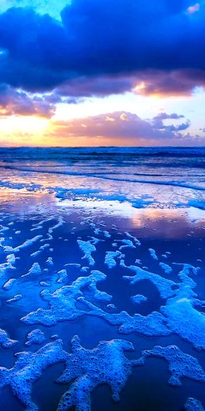 Breathtaking beach sunset phone wallpaper with vibrant colors and waves