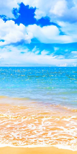 Breathtaking Beach Scene with Blue Sea and Dramatic Clouds