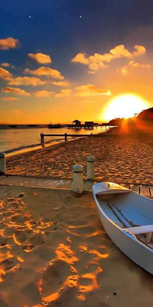 Beautiful Beach Sunset with Boat and Pier