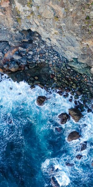 Aerial View of Rocky Shoreline and Turquoise Waters