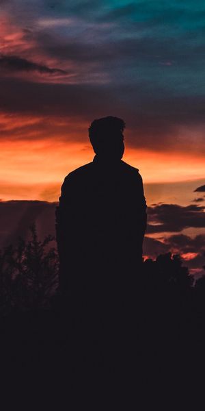 Silhouette of a Person Against a Stunning Sunset Sky