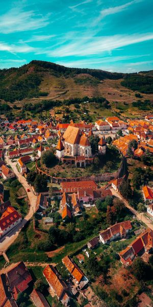 Aerial View of a Historic City Surrounded by Green Hills
