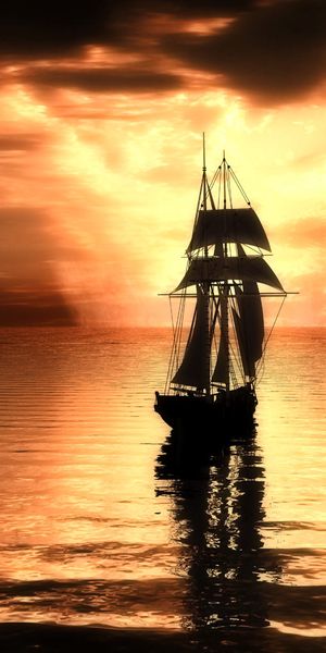 Breathtaking iPhone wallpaper featuring a ship at sunset over the ocean