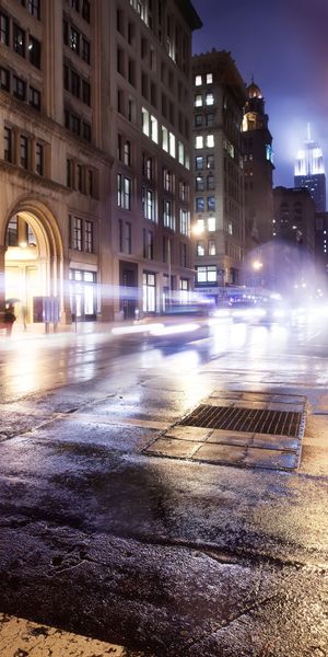Captivating Nighttime Cityscape with Umbrella and Rain - iPhone Wallpaper