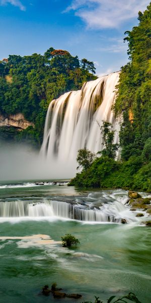 Breathtaking Waterfall Surrounded by Lush Nature