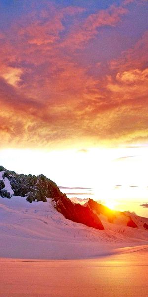 Breathtaking Sunset Over Snow-Capped Mountains