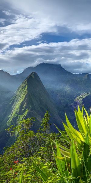 Majestic mountain wallpaper featuring lush greenery and dramatic skies