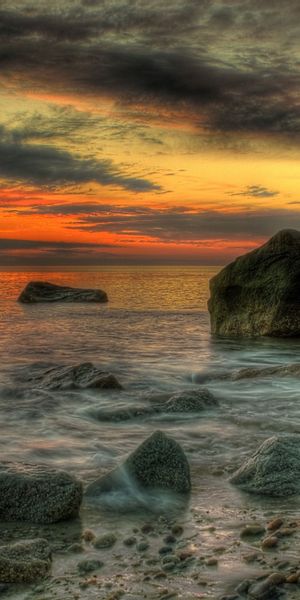 Breathtaking Sunset Over Rocky Shoreline - Perfect Mobile Wallpaper