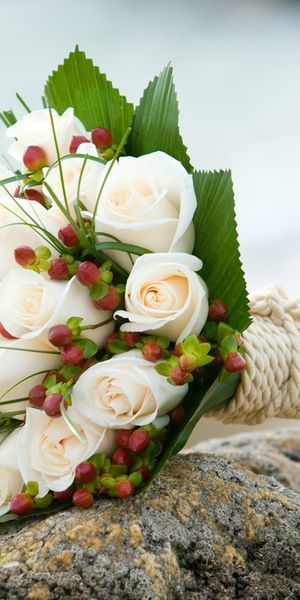 Trendy White Rose Bouquet on a Rock by the Shore