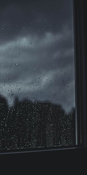 Dark Rainy Window with Smooth Drops and Atmospheric Blur