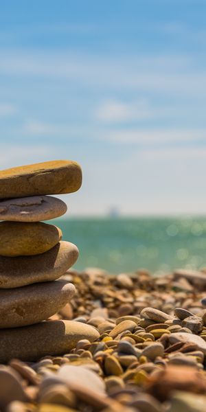 Beautifully Stacked Stones on a Tranquil Beach