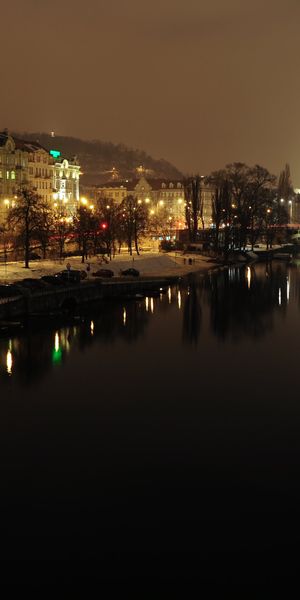 Enchanting Prague Nightscape: HD Phone Wallpaper of the City by the River