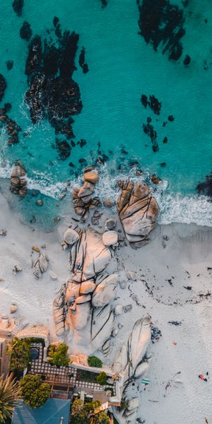 Breathtaking Aerial View of a Pristine Beach with Rocks and Sea