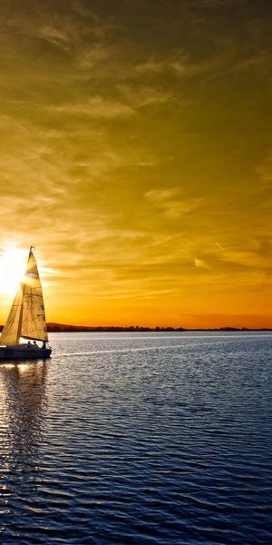 Beautiful Sailboat Sailing into the Sunset over the Ocean