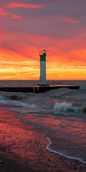 Breathtaking Sunset at Lighthouse Beach with Waves