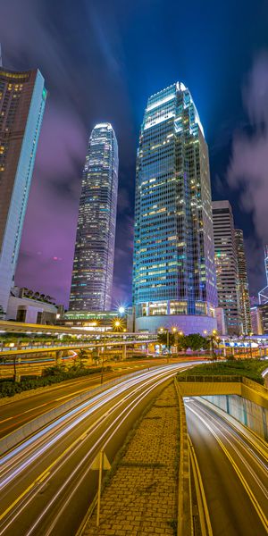 Free wallpaper of a bustling night city with skyscrapers and neon lights