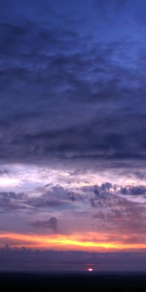 Beautiful phone wallpaper featuring a vibrant sunset over the earth and sky