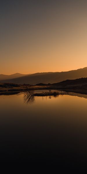 Serene Sunset Landscape with Reflection on a Calm Lake