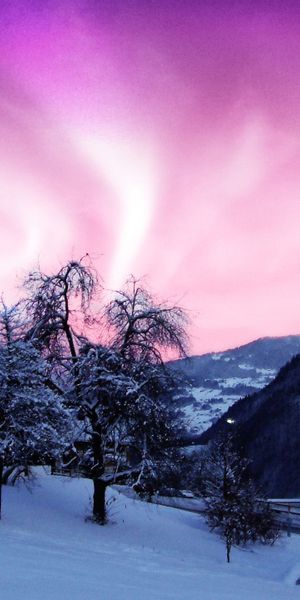 Breathtaking Aurora Borealis Above Snowy Mountains