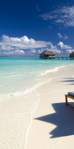 Relaxing Tropical Beach with Chair and Huts - Ideal Mobile Wallpaper