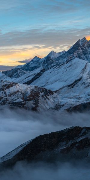Breathtaking Mobile Wallpaper of the Alps Summit in Switzerland with Fog