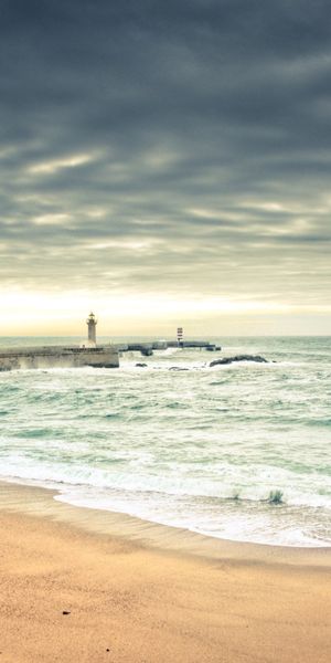 Serene Lighthouse by the Shore: A Beautiful 4K Phone Wallpaper for Nature Lovers