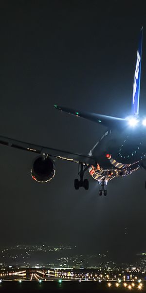 Night Aircraft Landing Over Cityscape - Perfect Mobile Wallpaper