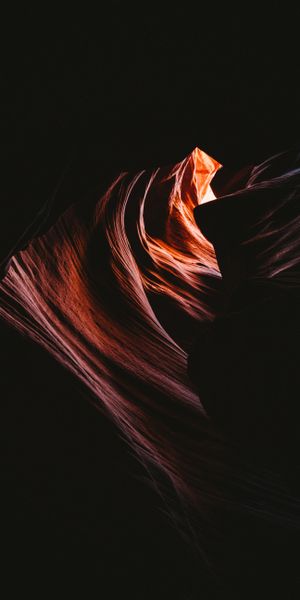 Captivating phone wallpaper featuring wavy cave rocks and dark relief