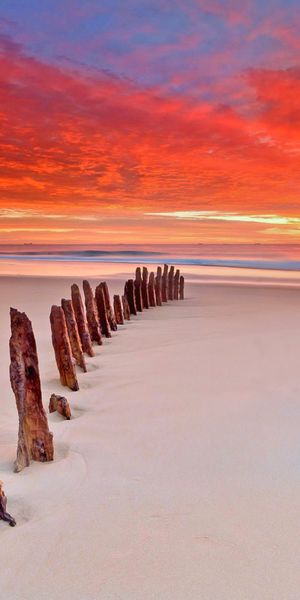Breathtaking Sunset Over the Sandy Beach with Cloudy Sky