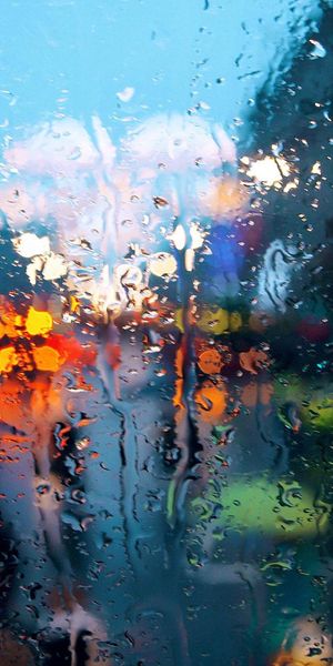 Beautiful Rainy Window View with Colorful City Lights
