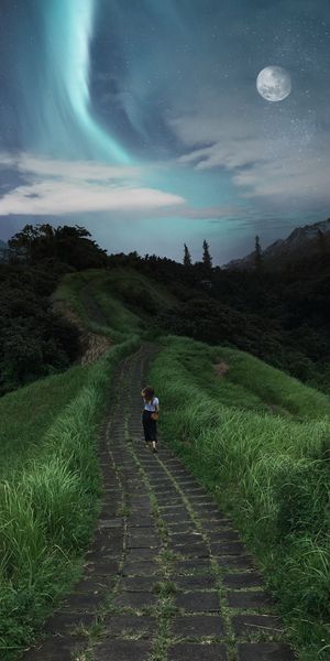 A Serene Girl Walking on a Path Under the Stars